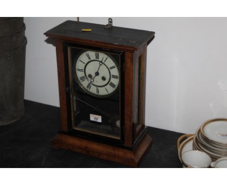 A late 19th century German walnut and ebonised cased mantle clock, the painted dial to the two train movement, striking on a 
