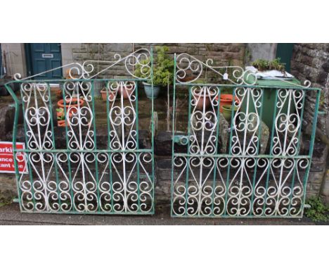 A pair of white and green painted wrought iron gates with scrolled motifs.  240 cm combined width x 140 cm high (one gate den