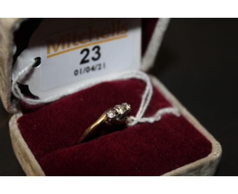 A 9ct gold three stone diamond engagement ring, the shank of cross-over style, combined approx 0.20 carat, ring size Q