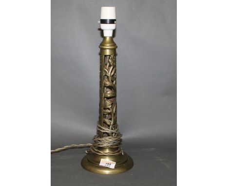 An early 20th century pierced brass electric table lamp base of Art Nouveau design, decorated with flowers, 30 cm high with l