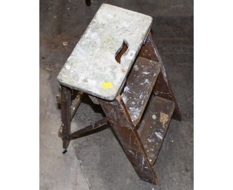 A vintage pine low step ladder, 58 cm high with various old paint residue.
