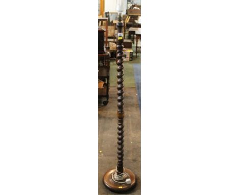 A 1920's oak standard lamp with spiral turned column on circular base, 148 cm high (slight split to top).