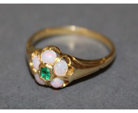 A gold coloured metal (thought 18ct gold), opal and emerald flower pattern ring with rectangular central stone approx 0.1 car