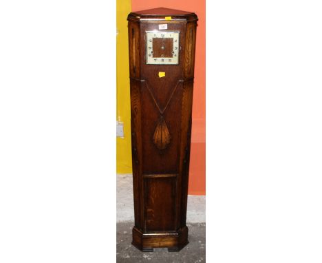 A 1930's oak grandmother corner clock of Art Deco design, striking on chimes, 32 cm wide x 25 cm deep x 135 cm high (glass to