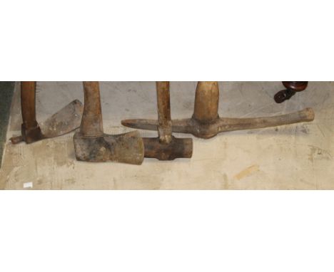 A group of three garden related tools to include an Adze, axe and sledge hammer 