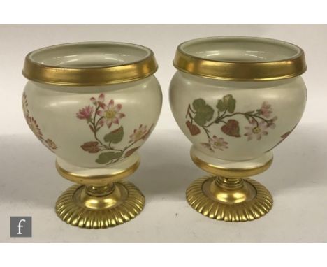 A pair of Royal Worcester vases of squat form, decorated with floral sprays to the ivory ground and later mounted to pedestal