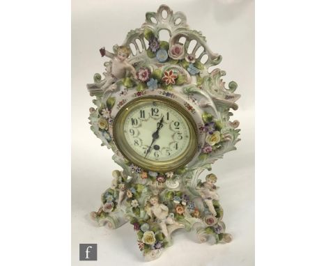 A 20th Century continental mantle clock with encrusted floral decoration and cherubs, height 39cm, A/F.