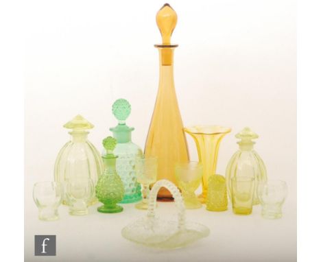 A collection of late 19th to early 20th Century uranium glass, to include a golden amber decanter of optic moulded tapering f