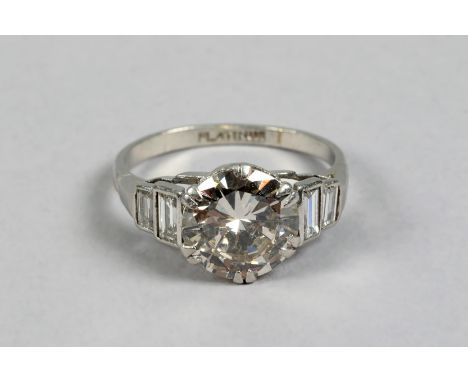 Ladies diamond solitaire ring, 2.5 carat brilliant cut diamond with two baggette cut diamonds to the shoulder, set in platinu