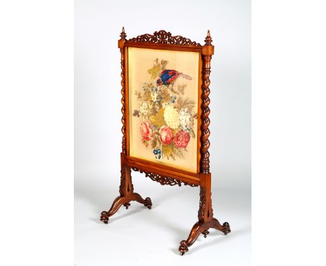 Victorian rosewood fire screen, pierced rail over a floral and parrot sewn work panel, spiral supports on scroll feet. 140cm 