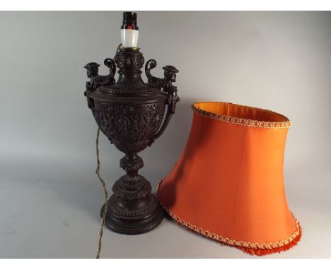 A Bronzed Cast Metal Table Lamp in the Form of a Two Handled Vase, Decorated in Relief with Masks Over Geometric Pattern