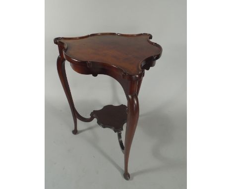 A Nice Quality 19th Century Mahogany Trefoil Shaped Tripod Table with Piecrust Border and Shaped Stretcher Shelf. 53cm Diamet