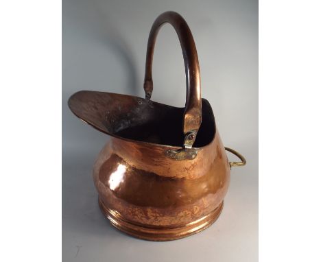 A Hand Hammered Arts and Crafts Helmet Shaped Coal Scuttle with Copper Loop Handle and Small Brass Handle