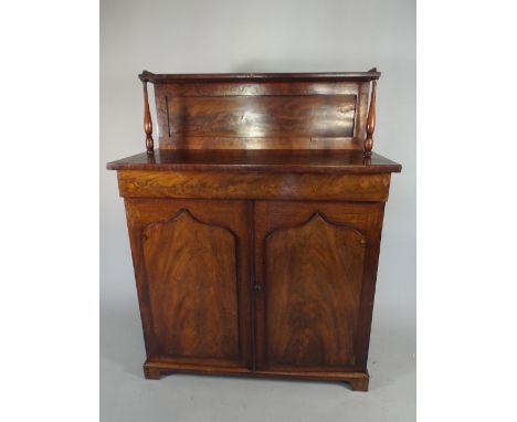 A Mid 19th Century Mahogany Chiffonier with Raised Gallery Shelf having Turned Supports, Centre Long Drawer and Panelled Door