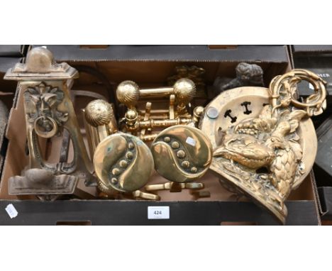 A pair of Art Nouveau brass fire dogs, to/w a pair of Arts &amp; Crafts brass andirons in the manner of Dresser, a brass door