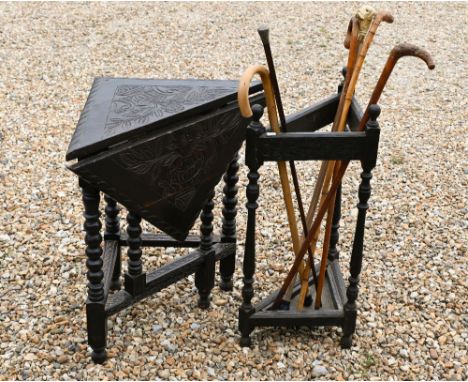 A 17th century credence style stained oak corner table, to/with an oak corner stick stand and sticks (2)