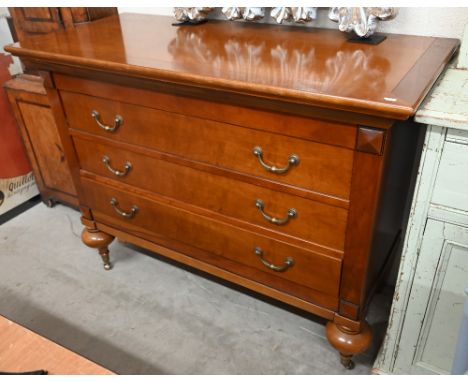 A French cherrywood three-drawer commode chest on turned supports with brass casters, 120 x 54 x 92 cm high