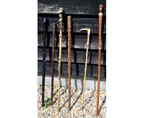 A folk-art oak walking cane, spiral carved with snakes and name 'William Martin Wingham', to/w a (possibly) Polynesian cane a
