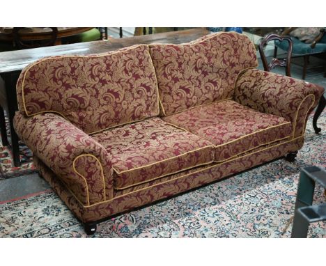 A large contemporary sofa in the manner of George Smith, upholstered in patterned damask and raised on turned stained wood fe