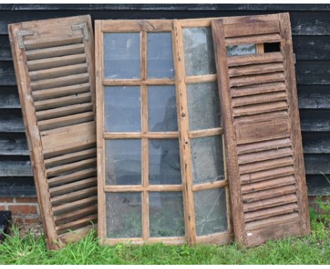 Two reclaimed pine sash window frames, 116 cm x 49 cm to/w a pair of reclaimed louvred shutter panels 44 cm x 117 cm h
