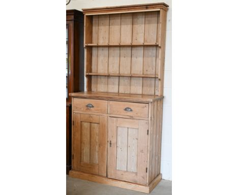 An antique pine dresser two shelf plate rack on base with drawers over panelled cupboards, 110 x 46 x 210 cm