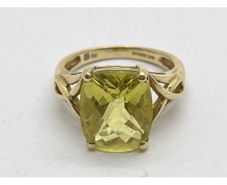 A 9ct Gold Stone Set Dress Ring, faceted cushion cut to centre, between tapered shoulders of openwork design (finger size K1/