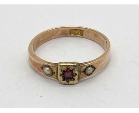 An Antique Pearl Set Ring, rose colour band with central star set detail, between pearl highlights, stamped "9ct" (finger siz