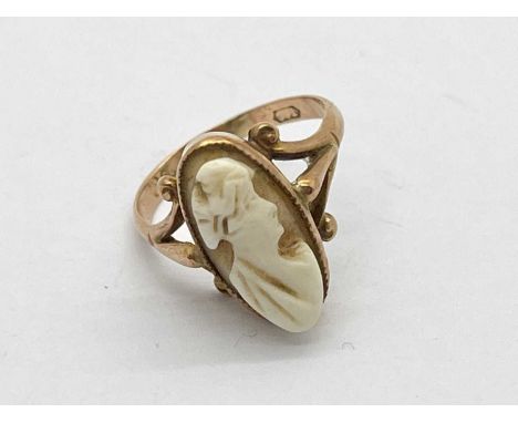 A Vintage 9ct Gold Cameo Dress Ring, (indistinctly hallmarked) oval collet set between trifurcated shoulders (finger size I).
