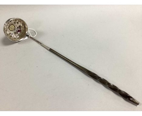 A Georgian Toddy Ladle, the circular bowl allover detailed with fruiting vines, with inset 1763 threepence coin (previously g