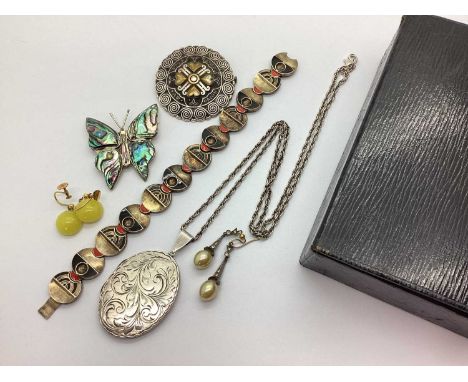 A Large Oval Hallmarked Silver Locket Pendant, leaf scroll engraved to the front, on a twisted chain; Pierre Peron for Kelt B