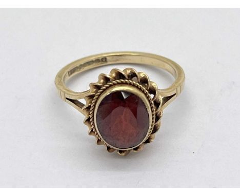 A 9ct Gold Garnet Single Stone Ring, oval collet set (finger size L) (2.3grams).