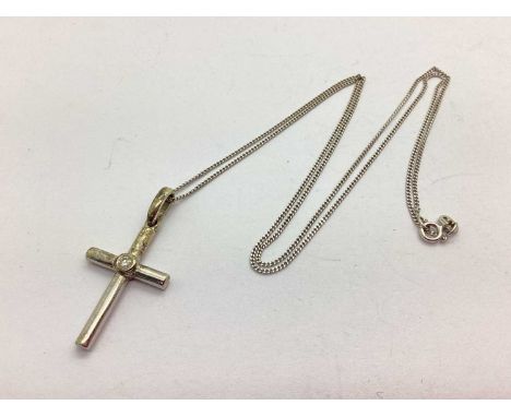 A 9ct White Gold Dainty Cross Pendant, stone rubover set to centre, suspended on a 9ct white gold dainty fine link chain, 52c