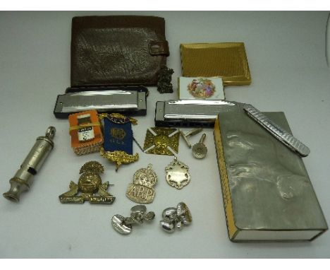 A silver A.R.P. badge, a silver fob, military badges, two harmonicas, a cigarette case, a whistle, etc.