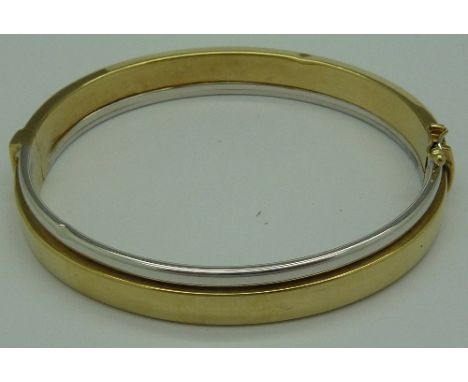 A 9ct white and yellow gold bangle, weight 13.7g