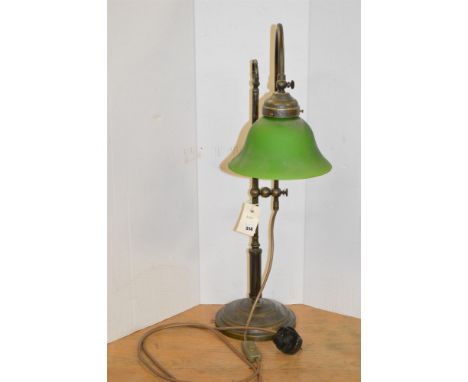 A reproduction bronzed reading lamp with green glass shade.
