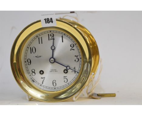 Chelsea Clock Co: a 'Ship's Bell' bulkhead clock, the silvered arabic dial with S/F lever towards the 10 o'clock.