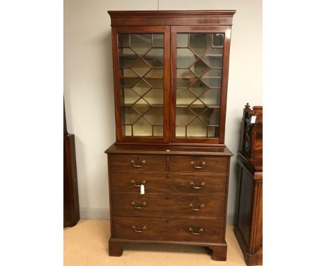 An early 20th Century mahogany chest of two short and three long drawers, raised on bracket feet, 102cms high; together with 