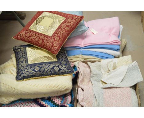 Three boxes of mixed textiles, to include Durham quilts; blankets; and pillows.