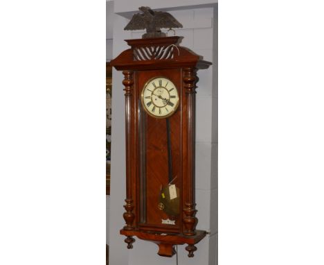 A late 9th Century mahogany cased German/Vienna style wall clock, the roman dial and seconds subsidiary dial, with pierced an
