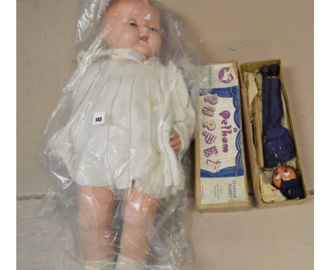 A composition doll; and a Pelham puppet policeman.
