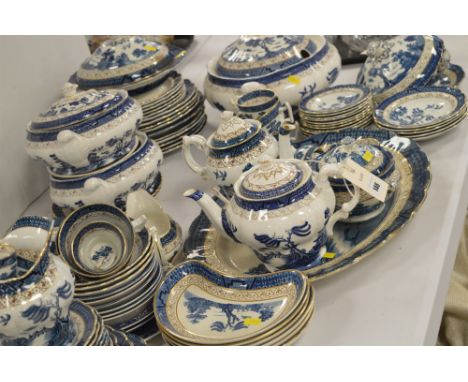 A large quantity of Booths 'Real Old Willow' pattern dinner ware, to include: tureens; plates; tea pot; coffee pot; cups and 