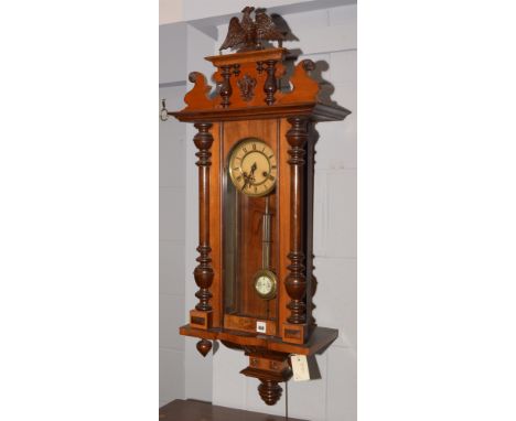 A 19th Century mahogany Vienna wall clock, with roman dial, bi-metallic pendulum, eagle finial, 90cms high.