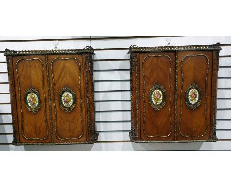 Pair of French wall-hanging two-door ormolu and kingwood cabinets with three-quarter galleried brass tops above the slight se