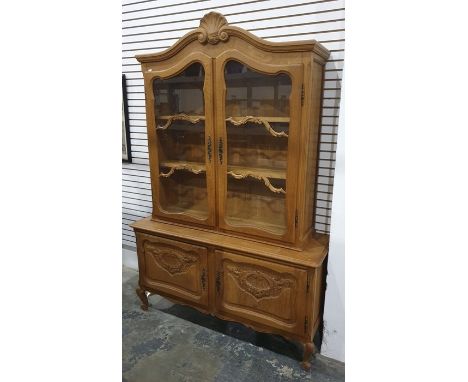 20th century oak cabinet in the French Louis XV taste, the pediment surmounted by shelf motif above the two glazed doors encl