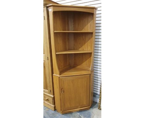 Light coloured Ercol corner display cabinet, three shelves above cupboard door&nbsp;