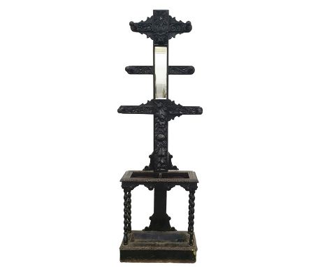 Victorian gothic style coat and umbrella stand&nbsp;with carved decoration, central rectangular mirror, the whole ebonised wi