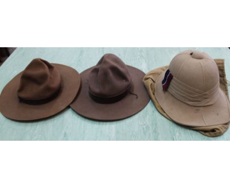 A pith helmet with cover plus two others