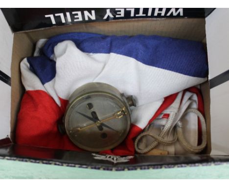 A brass compass with two flags