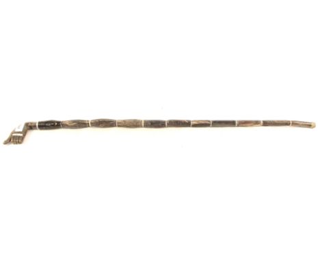 A horn sectional walking stick with white metal work, concealing a dagger