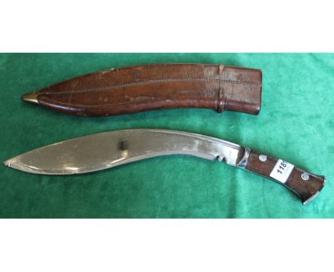 A WWII military issue Kukri, blade marked J.N.B.43 within its correct leather scabbard